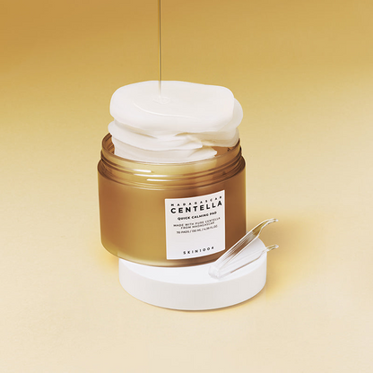 Tarro abierto de Skin1004 Madagascar Centella Quick Calming Pad de 130 ml con almohadillas blancas apiladas sobresaliendo y chorro de suero cayendo sobre ellas, sobre fondo amarillo degradado